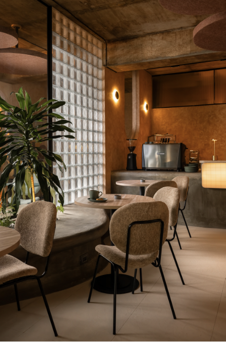 Contemporary interior lounge with concrete walls, patterned tile, and staircase