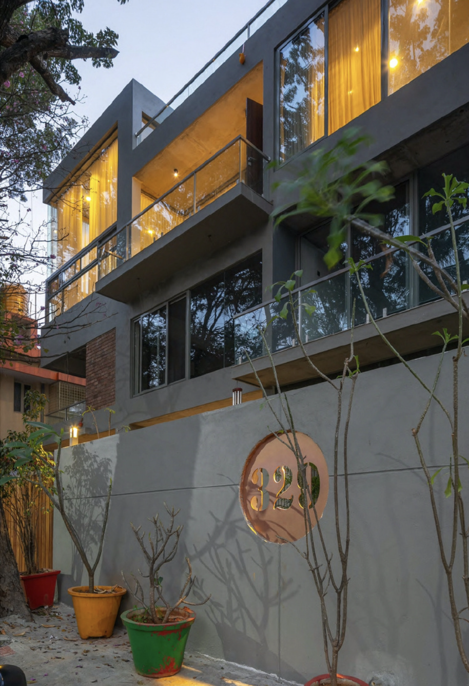 Multi-storey modern facade with glass balconies at evening